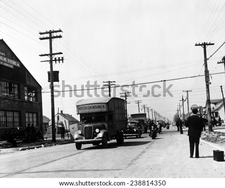 Integration. A convoy of African-American moving trucks protected by police cars. Whites had protested integration of the Sojourner Truth homes, a new U.S. federal housing project. Detroit, Michigan,