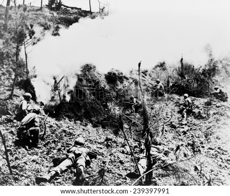 Okinawa. After setting off explosives, Marines wait at entrance to cave in which Japanese soldiers are hiding.\