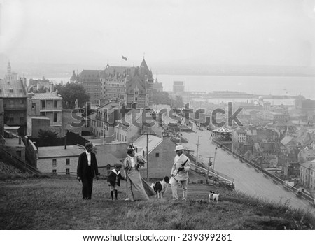 A family walks on the heights of Quebec City. Le Ch_teau Frontenac in the background is still the premier Quebec City landmark. 1910\'s.