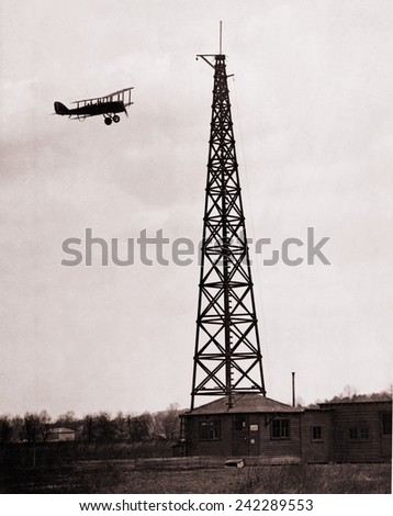 First radio beacon station, with the operating shack and antenna system at College Park, Maryland. Airplane used the radio signals for navigation. 1928.
