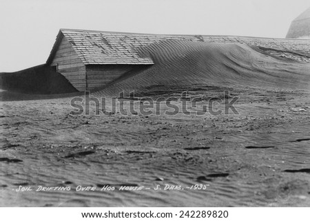 Soil drifting over a farm building on a South Dakota farm in 1935. Dakota was north of the 'Dust Bowl,' but the 1930s drought and decades of intensive farming on the Great Plains.
