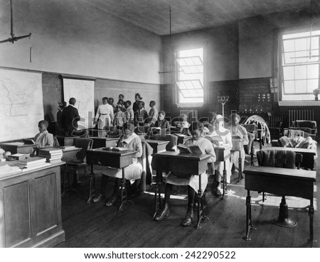 African American students in geography class at Thaddeus Stevens School. The school was a fresh air school, with large windows allowing good ventilation. CA. 1910.