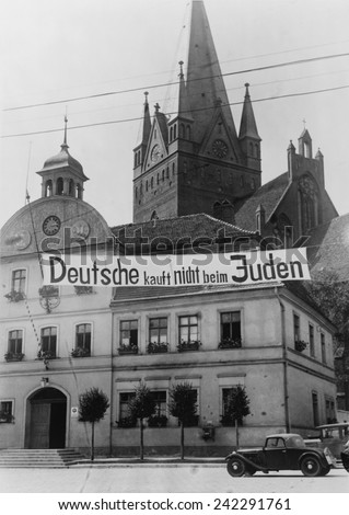 Banner reading \'Deutsche kauft nich beim Juden\' (Germans don\'t buy in Jewish shops) suspended over a street in Greifenberg, Pommerania (now Poland). 1935.