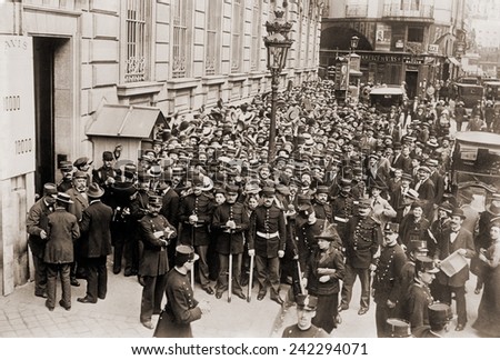 Paris police hold back a crowd making a run on a French bank. Ca. 1905-1915.
