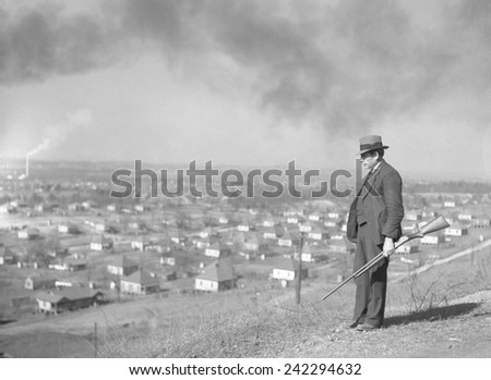 An armed private guard watches over a steel mining company town in Jefferson County, Alabama, in 1937. 1937 photo by Arthur Rothstein.