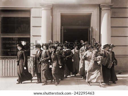 Women workers leave the offices of the Chesapeake and Potomac Telephone Company. 1914.