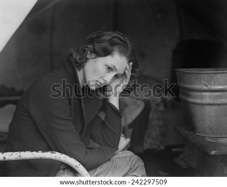 Sad daughter of unemployed Tennessee coal miner in California migrant workers camp near Sacramento, California, during the Great Depression. Photo by Dorothea Lange, 1936.