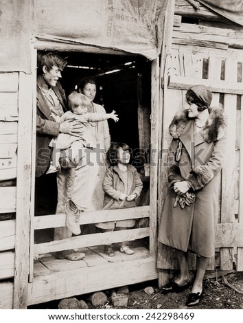 A family of poor sharecroppers at their Arkansas farm home welcome a Red Cross worker during the great drought of 1930-31.