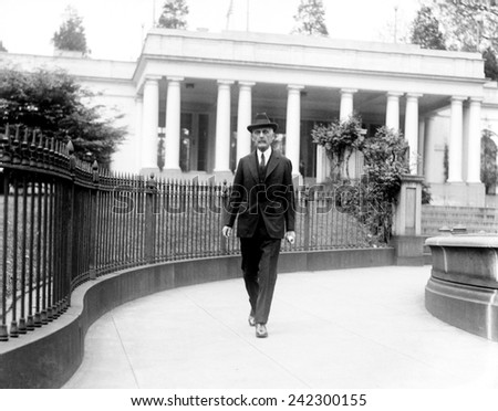 Andrew Mellon (1855-1937), industrialist and politician, then secretary of the Treasury, walking near the White House during the Harding Administration. 1921.