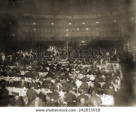 Salvation Army\'s New Year\'s Dinner in a large auditorium was attended mostly by men, but also women, children, and African American families, 1910