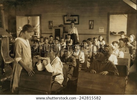 1912 hygiene education in an Oklahoma school. One of the older students performs as daily inspection of teeth and finger nails for under the direction of the teacher. Photo by Lewis Hine.