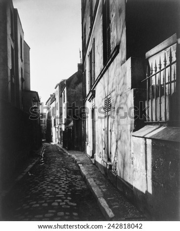 Narrow street, Rue St. Rustique, in Paris, France by Atget, Eugene, (1857-1927). Atget photographed Paris and its people with a large-format wooden bellows camera from the 1890s through the 1920s.
