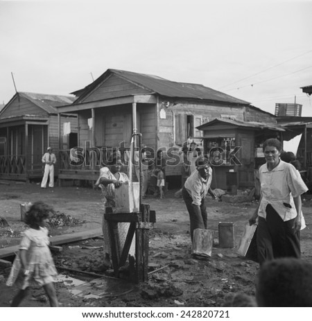 One pump is the community water supply in the workers' quarter of Porta de Tierra, part of San Juan, Puerto Rico. January 1938 photo by Edwin Rosskam.