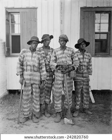 Four African American youths in a Southern chain gang. Southern jails made money leasing convicts for forced labor in the Jim Crow South. Circa. 1900