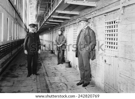 Thomas Mott Osborne (at right), Warden of Sing Sing prison in a cell block with guards. He instituted reform and rehabilitation programs at Sing Sing and later founded Mutual Welfare League. Ca. 1914.