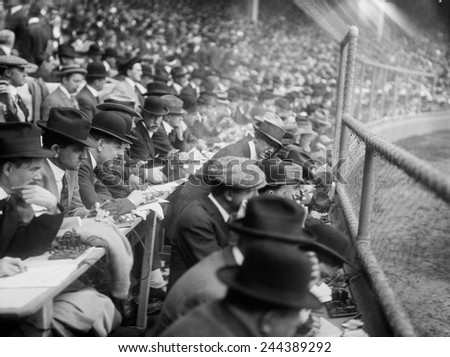 Baseball games were reported via telegraph operators and the action and changing scores were posted to large public scoreboards. Polo Grounds, New York City, October 9, 1913.