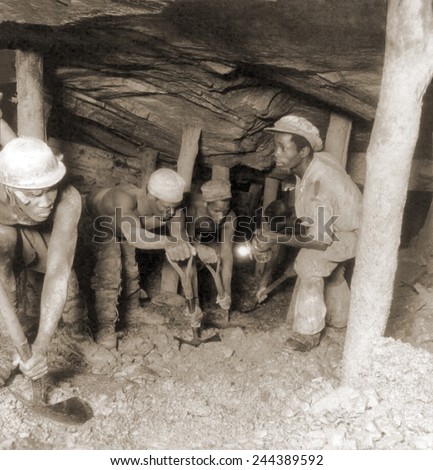 African gold miners developing a drift, a tunnel following a vein of ore, in the Crown Mine, in the greatest gold bearing region of the world, near Johannesburg, South Africa. 1935.