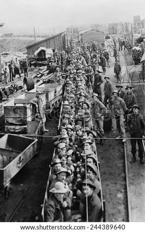 Dozens of men in open railroad cars on their way into the underground mines in Idaho in 1909.