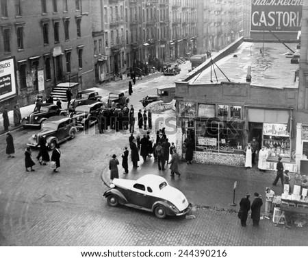 Federal Bureau of Narcotics agents blockade streets with their cars in a drug bust in the San Juan Hill neighborhood of New York City 1939.