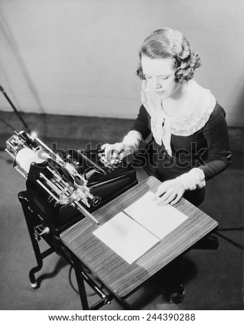 Young female government employee using an adding machine. Ca. 1935.