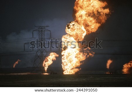 Kuwaiti oil wells set on fire by retreating Iraqi forces during Operation Desert Storm darken the sky with smoke. Mar. 25 1991