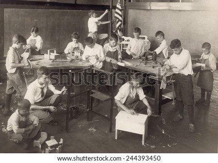 Boys learn carpentry in an open air summer school in Chicago in 1917.
