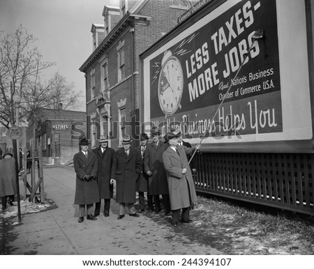 Members of the National Chamber of Commerce at their anti-tax billboard. The Chamber was one of several business organizations that opposed New Deal programs. Jan 19, 1939 in Washington D.C. area.