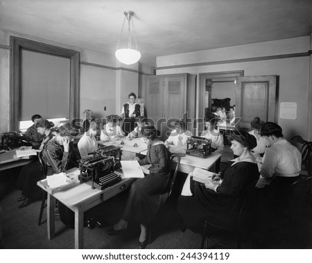 Office with many women performing clerical and secretarial work in a U.S. Government office. A posted sign bears heading \'Notice of Hours of Labor of Female Employees.\' Ca. 1915.