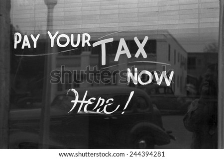 Sign reading PAY YOUR TAX NOW HERE in Harlingen Texas Feb. 1939 photo by Russell Lee.