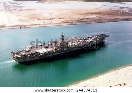 Aircraft carrier JOHN F. KENNEDY in the Suez Canal traveling home to Norfolk Virginia after a seven month deployment during the First Iraq War. 1991. Mar. 1 1991.