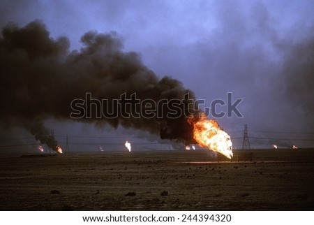 Kuwaiti oil wells set on fire by retreating Iraqi forces during Operation Desert Storm darken the sky with smoke. Mar. 1 1991