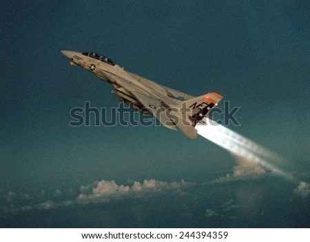 F-14 Tomcat Fighter climbs with its afterburners ignited during a take-off of the aircraft carrier USS RANGER. May 1 1989.
