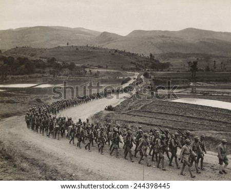 World War II. Chinese soldiers marching on the Burma Road toward the fighting lines on the Salween River front. 1943 photo by Frank Cancellare.
