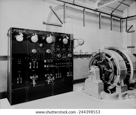 Control panel and dynamo (generator) of a self-contained electric power station that might be used for a large house or small factory before electricity was available from public utilities.