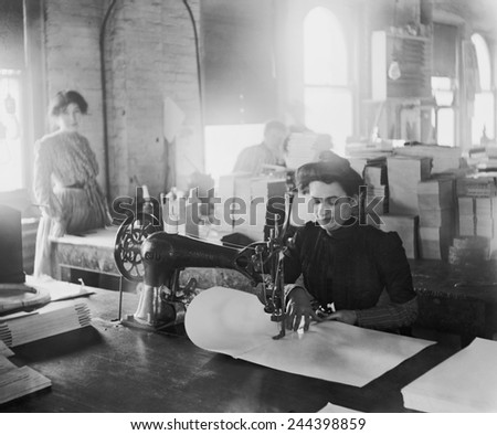 Middle-aged woman sewing on a belt driven Singer machine at the Richmond & Backus Company, Detroit, Michigan, ca. 1905.