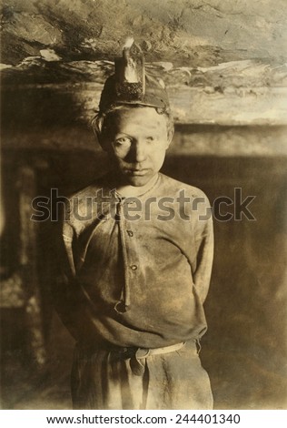 A Trapper Boy, whose job was to wait in the dark mine, opening and closing a door connecting one mine chamber to another. Turkey Knob Mine, Macdonald, West Virginia. October 1908 photo by Lewis Hine.