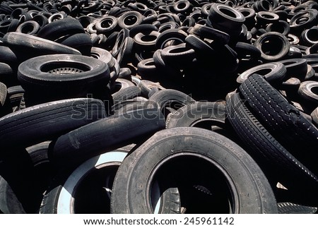 Dump of discarded automobile tires that are to be burned creating a pollution smoke hazard. Ca. 1973-75.
