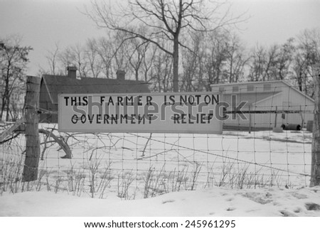 \'This Farmer is not on Welfare \' reads a sign a wire fence. Iowa or Illinois Dec. 1940.
