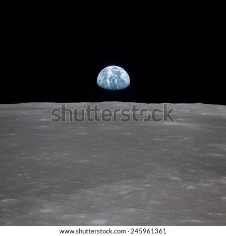 Apollo 11 Earth rise over the Moon. Earth on the horizon in the Mare Smythii Region of the Moon. Image 5 of a NASA sequence of 18. July 20, 1969.