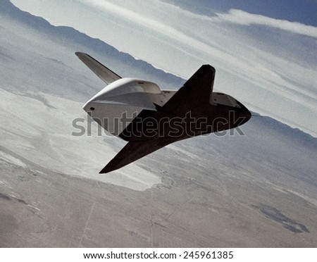 Test of the space shuttle prototype Enterprise in a free flight glide and landing on Rogers Dry Lake bed. During the test, pilots and engineers test the Space Shuttle\'s handling. 1977.