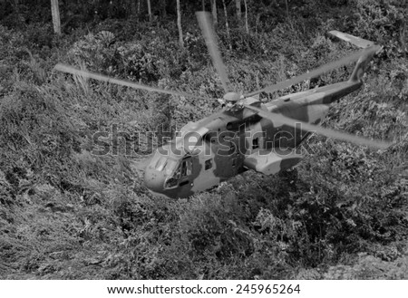 An unmarked US Air Force helicopter landing in Southeast Asian jungle during operation \'Pony Express.\' Pony Express provided covert transport for indigenous soldiers. June 1968.