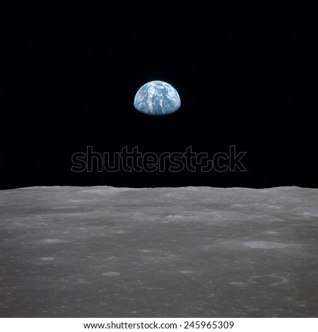 Apollo 11 Earth rise over the Moon. Earth on the horizon in the Mare Smythii Region of the Moon. Image 14 of a NASA sequence of 18. July 20, 1969.