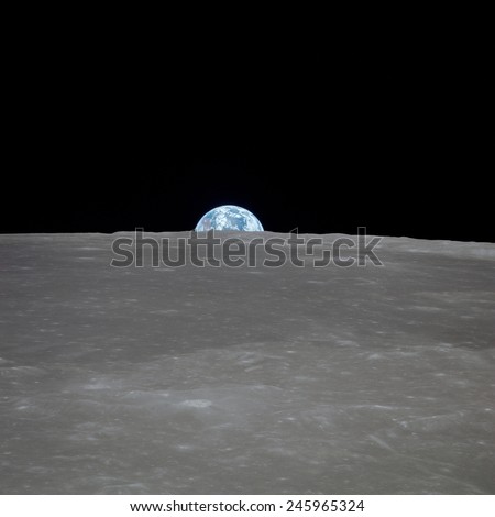 Apollo 11 Earth rise over the Moon. Earth on the horizon in the Mare Smythii Region of the Moon. Image 1 of a NASA sequence of 18. July 20, 1969.