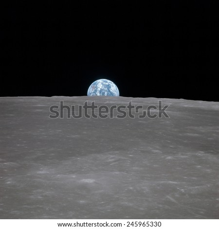 Apollo 11 Earth rise over the Moon. Earth on the horizon in the Mare Smythii Region of the Moon. Image 2 of a NASA sequence of 18. July 20, 1969.