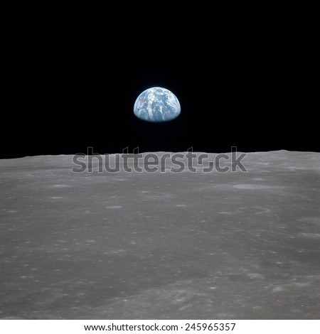 Apollo 11 Earth rise over the Moon. Earth on the horizon in the Mare Smythii Region of the Moon. Image 6 of a NASA sequence of 18. July 20, 1969.