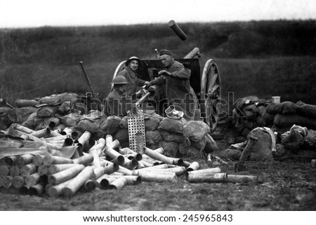American Field Artillery on the Lorraine front in Beaumont, France. An ejected shell case flies through the air as a new shell is put into the breech in the same a second. WWI. Sept. 12, 1918.