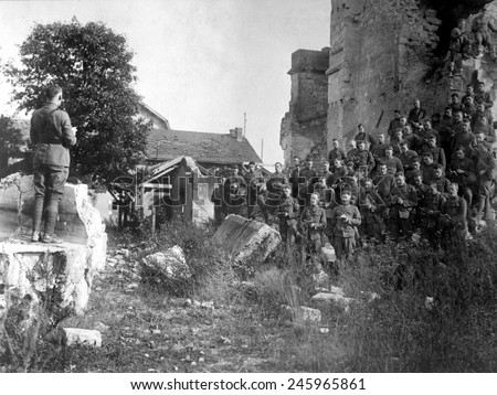 WWI American soldiers of the 101st Field Signal Battalion at services in the ruins of a church destroyed by shell fire. Verdun, France. Oct. 18, 1918.