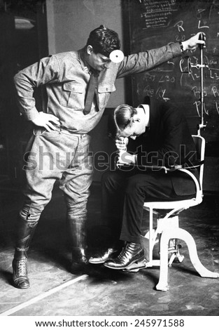 Physical examination of an aviation recruit\'s to the \'falling test\'. It tests the sixth sense, that of equilibrium, the function of the labyrinth of the internal ear. WWI. March 19, 1918.