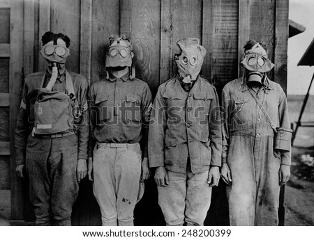 Soldiers wearing WW1 gas masks. L-R: American, British. French, German. 1917-18.
