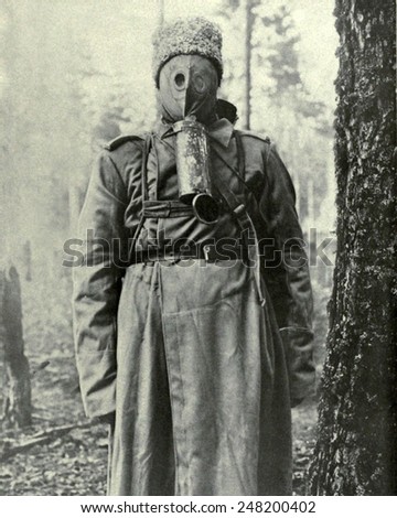 Russian primitive type of gas mask used in WW1. 1917. The rubber mask covers the face and the soldier breaths through a hole on top of the tin which is filled with charcoal and chemicals.